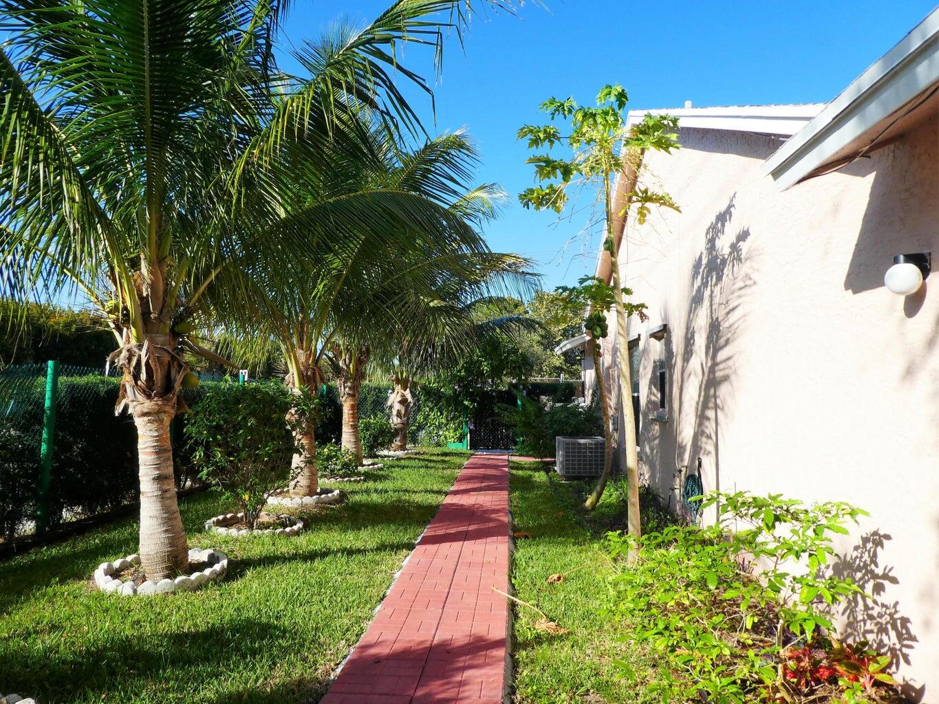 300 Northeast 42nd Street Boca Raton, FL 33431 - Photo 24 of 53 a garden view with a fountain