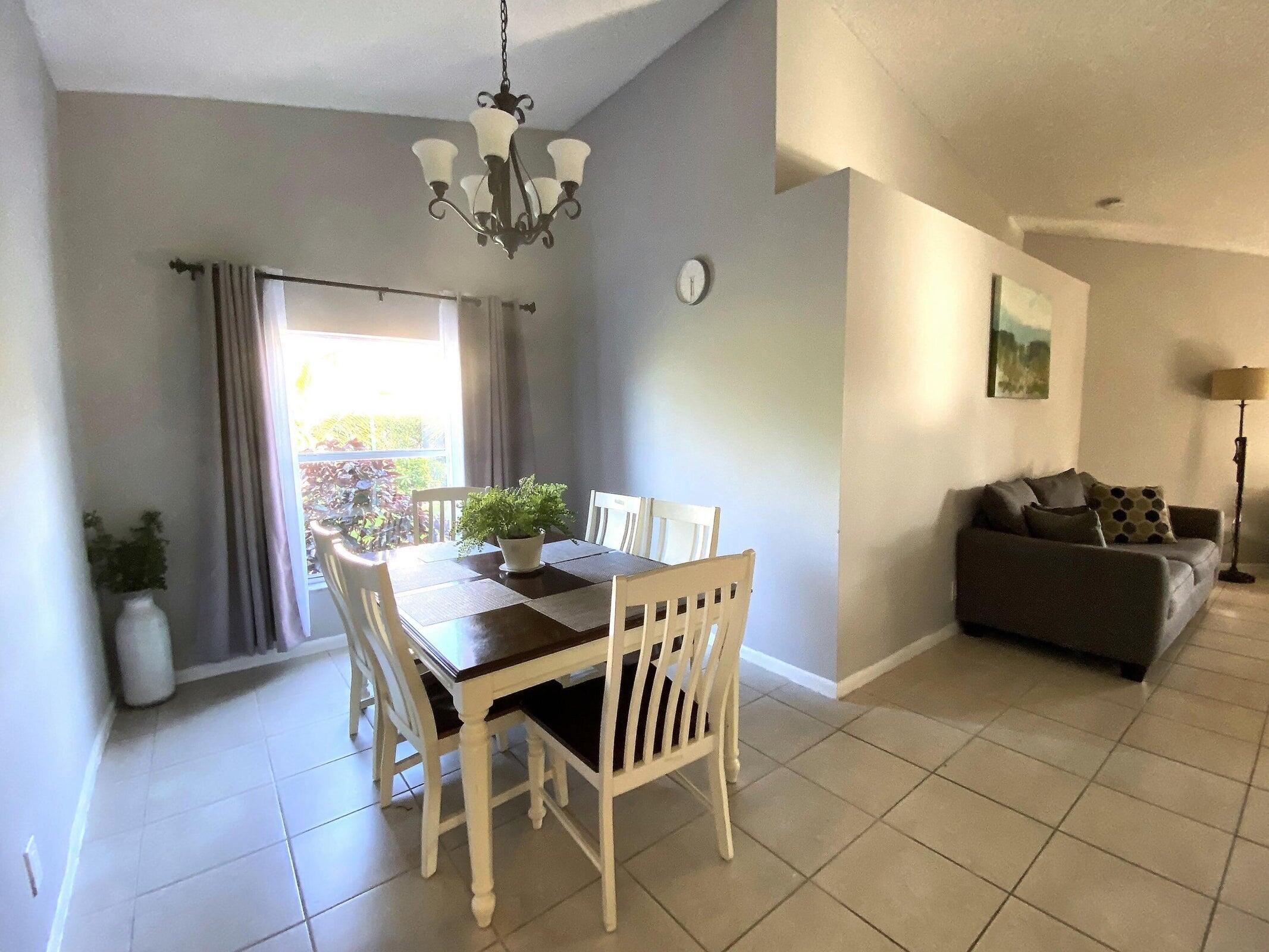 300 Northeast 42nd Street Boca Raton, FL 33431 - Photo 31 of 53 a view of a dining room with furniture and a chandelier