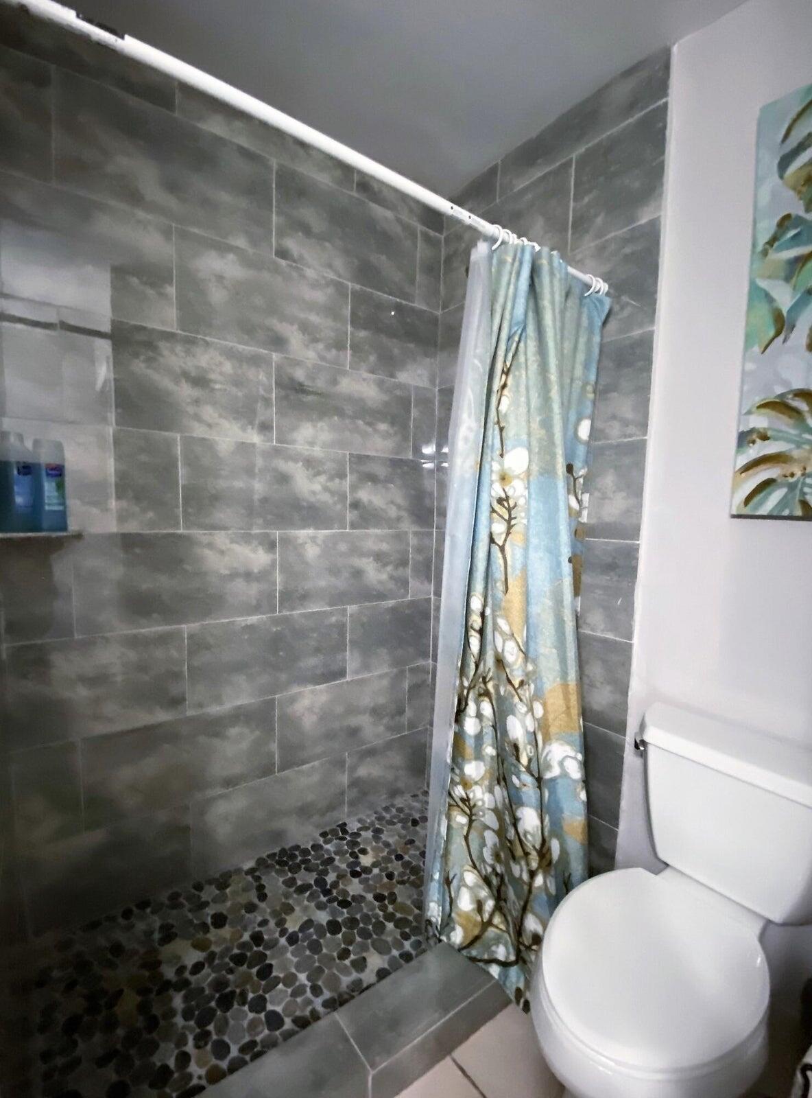 300 Northeast 42nd Street Boca Raton, FL 33431 - Photo 35 of 53 a bathroom with a toilet and shower