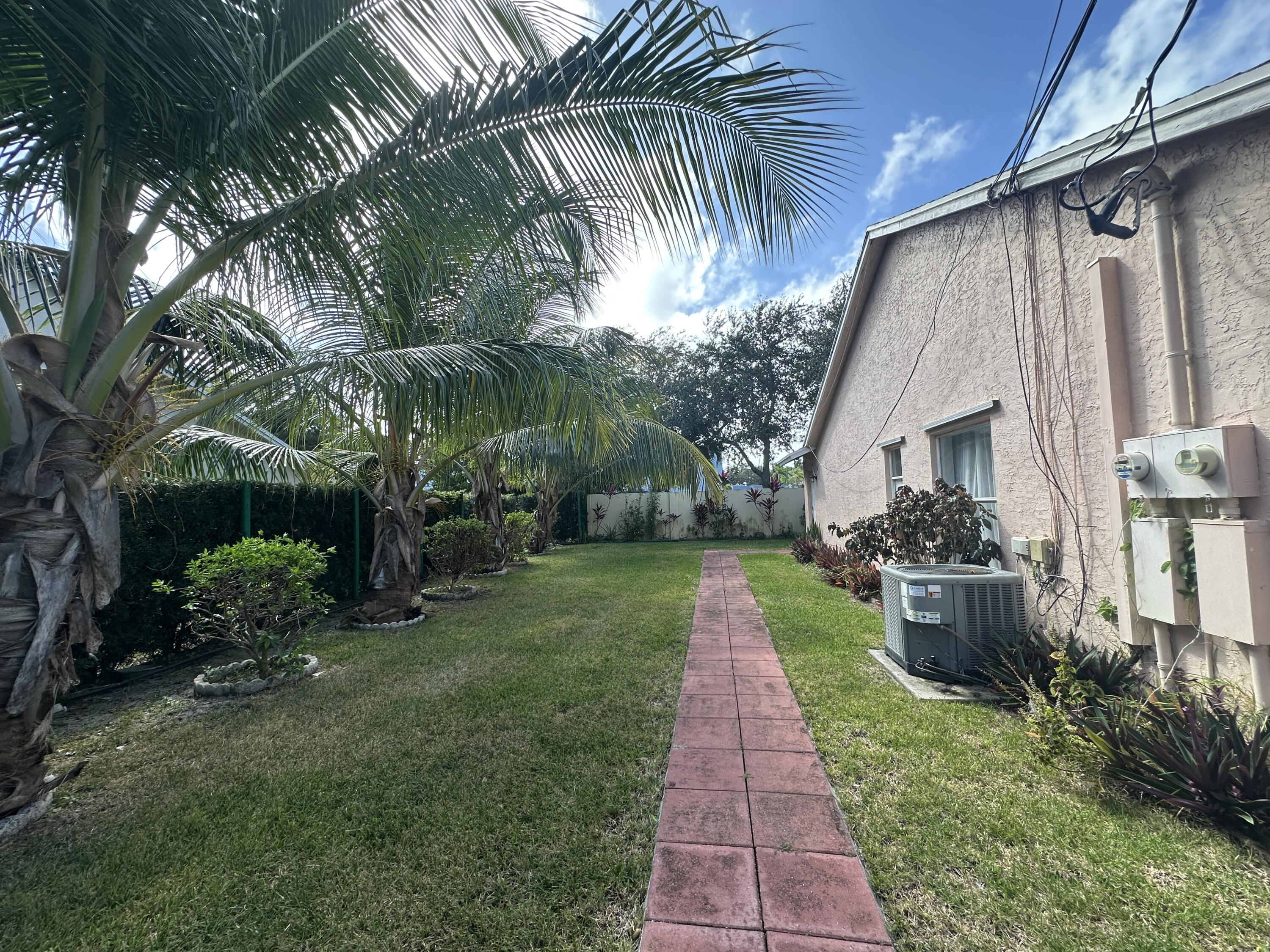 300 Northeast 42nd Street Boca Raton, FL 33431 - Photo 39 of 53 a front view of a house with a garden
