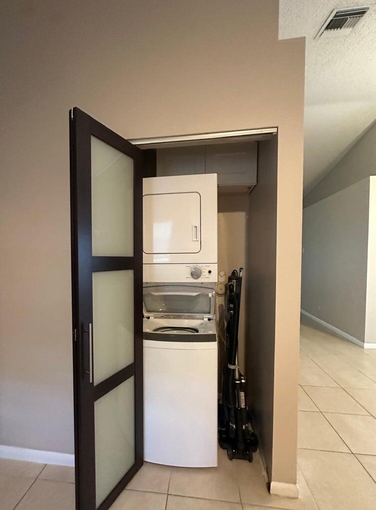 300 Northeast 42nd Street Boca Raton, FL 33431 - Photo 4 of 53 a kitchen with a refrigerator and cabinets