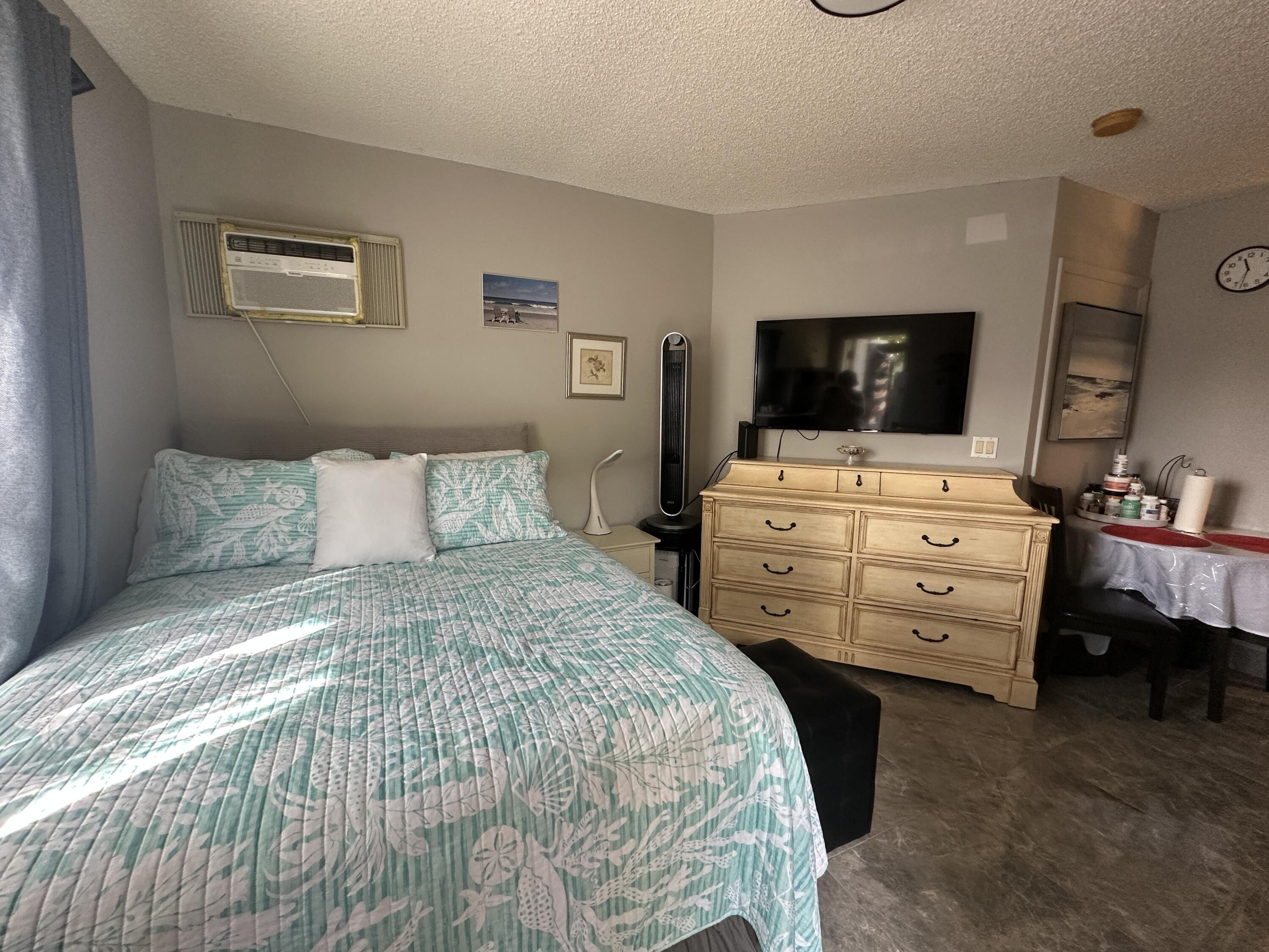 300 Northeast 42nd Street Boca Raton, FL 33431 - Photo 41 of 53 a bedroom with a bed and a flat tv screen