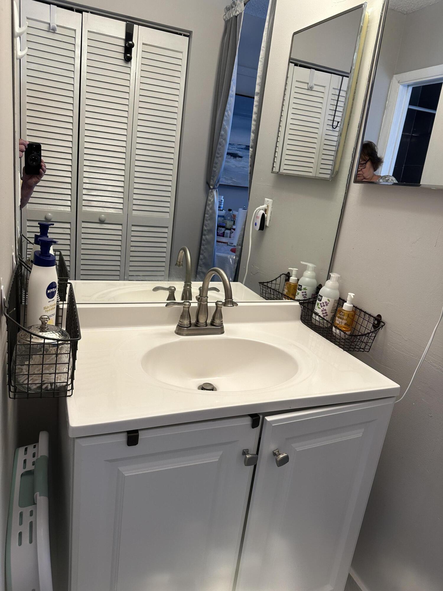 300 Northeast 42nd Street Boca Raton, FL 33431 - Photo 44 of 53 a bathroom with a sink and a mirror