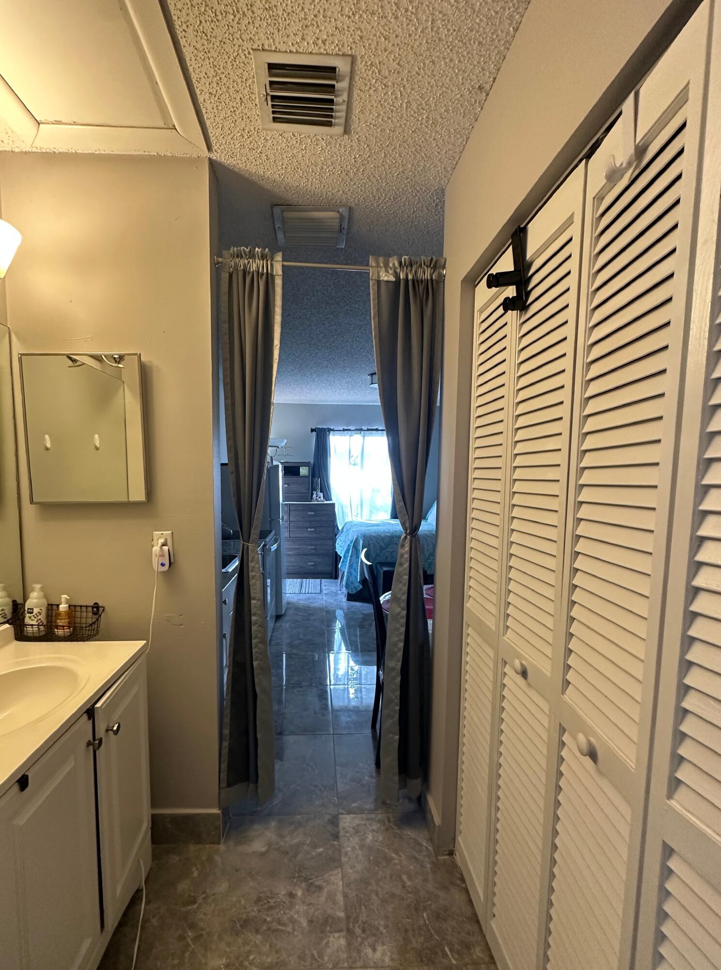 300 Northeast 42nd Street Boca Raton, FL 33431 - Photo 47 of 53 a bathroom with a sink a mirror and shower