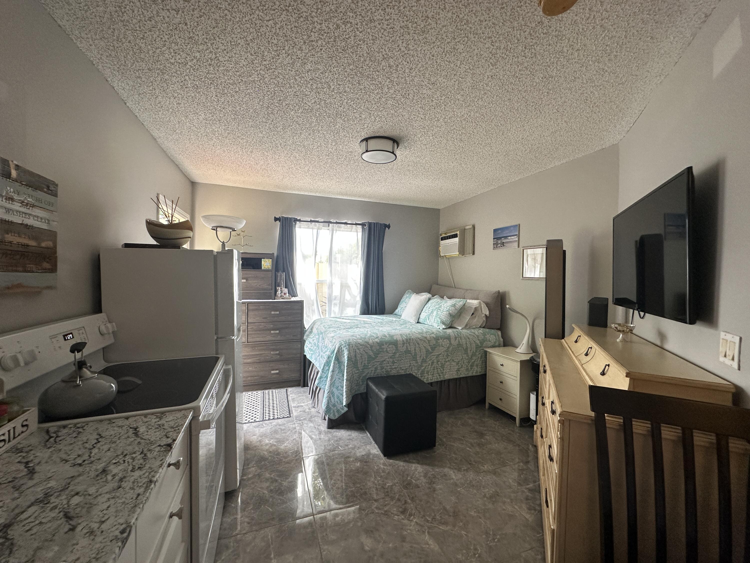 300 Northeast 42nd Street Boca Raton, FL 33431 - Photo 48 of 53 a living room with furniture and a flat screen tv