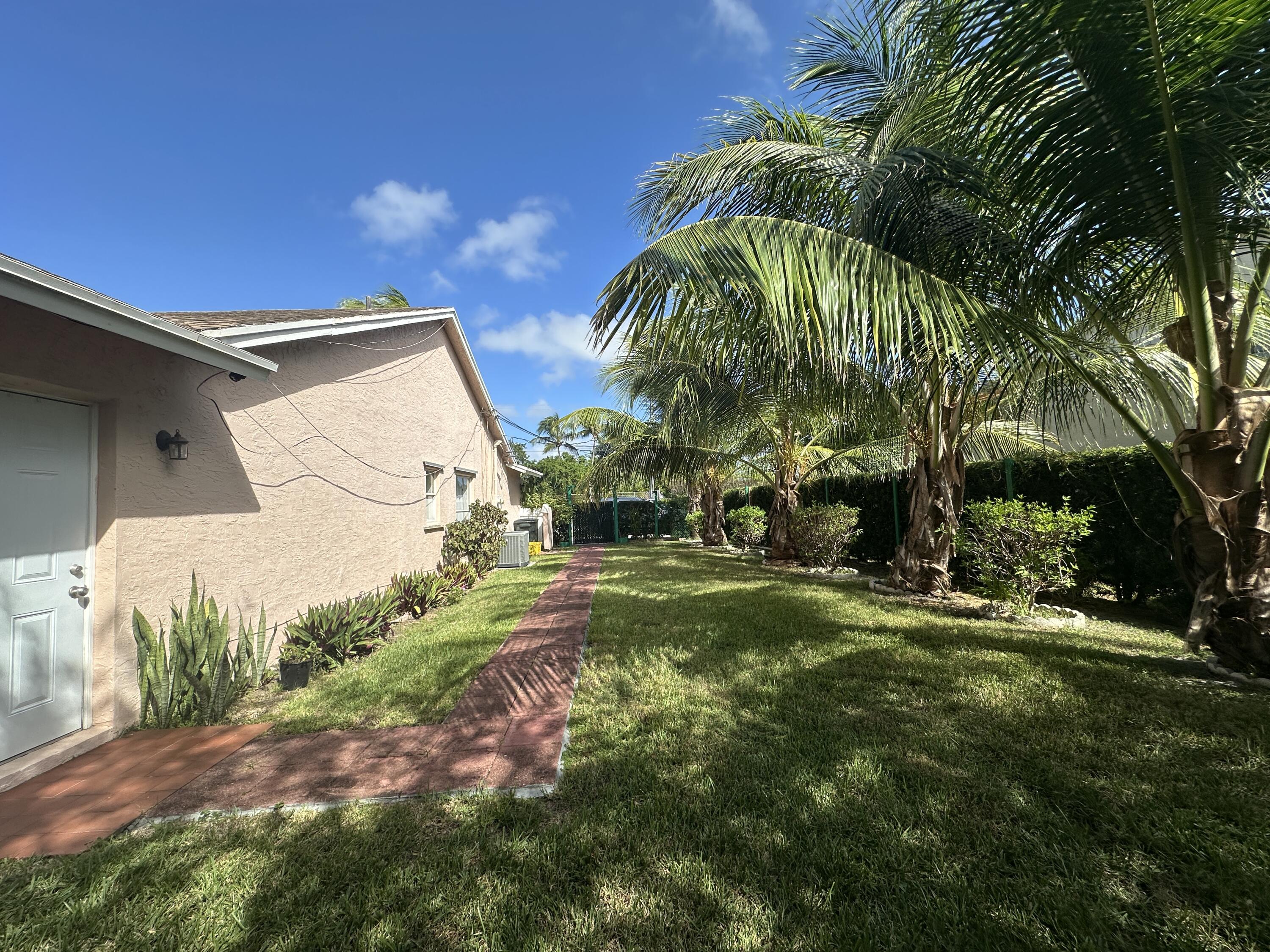 300 Northeast 42nd Street Boca Raton, FL 33431 - Photo 52 of 53 a view of a house with a yard