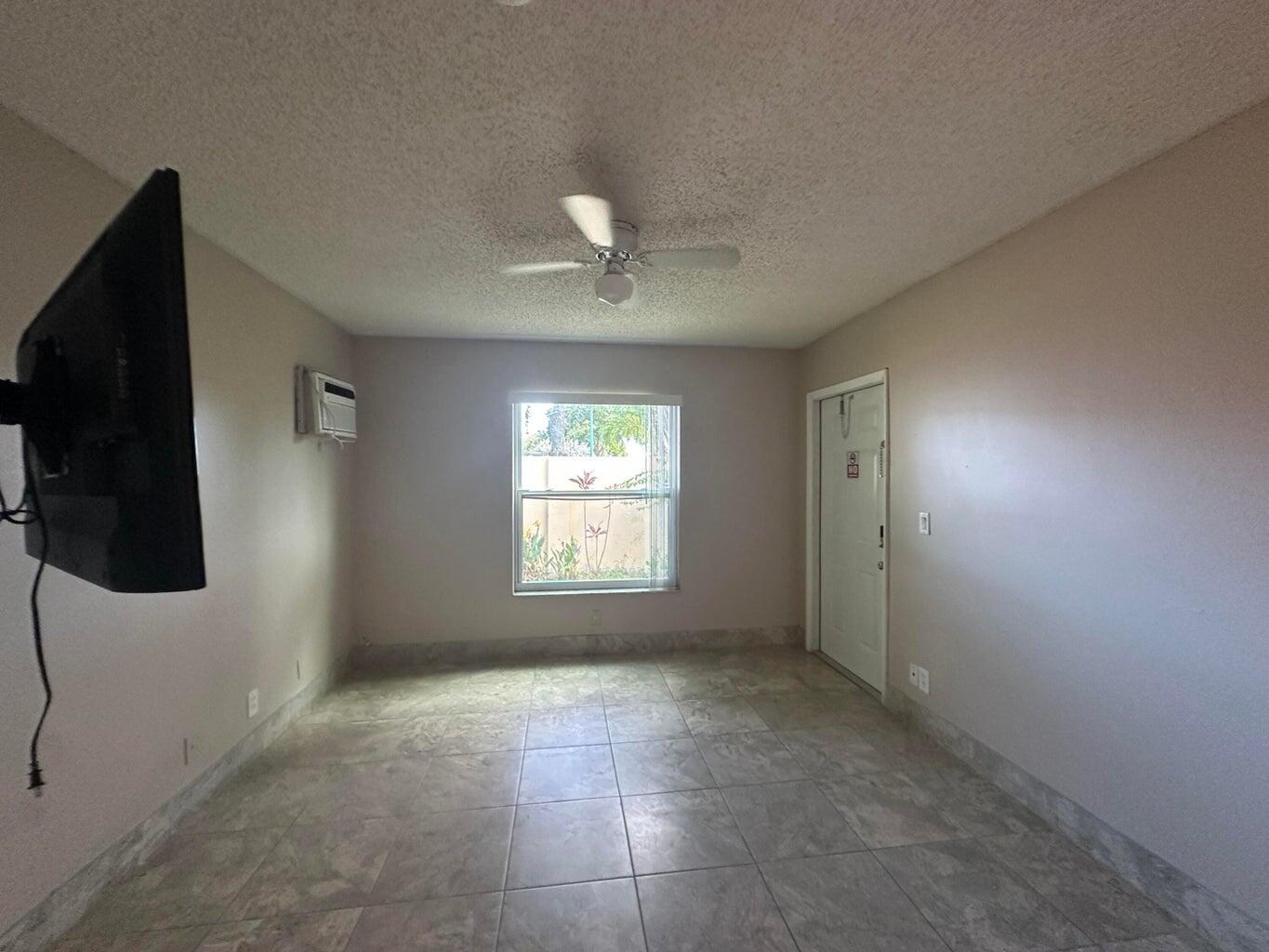 300 Northeast 42nd Street Boca Raton, FL 33431 - Photo 6 of 53 a view of an empty room with a window