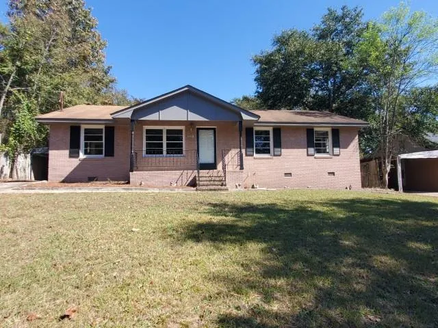 a front view of house with yard and green space