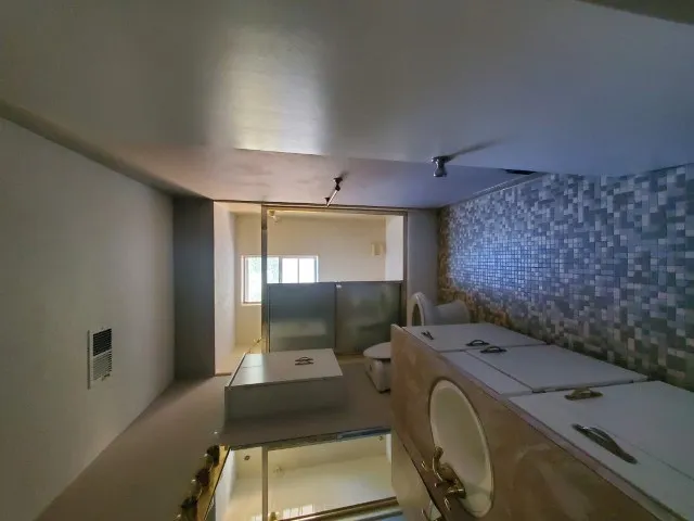 a bathroom with a toilet mirror and vanity