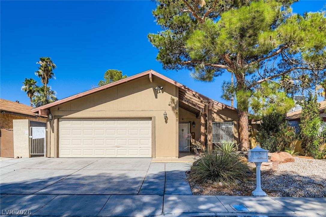 4723 Desert Vista Road Las Vegas, NV 89121 - Photo 1 of 29 Ranch-style house with an attached garage and concrete driveway
