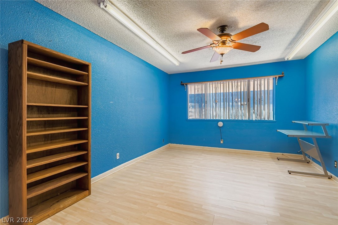 4723 Desert Vista Road Las Vegas, NV 89121 - Photo 14 of 29 Primary room featuring a textured ceiling, wood finished floors, a textured wall, and ceiling fan