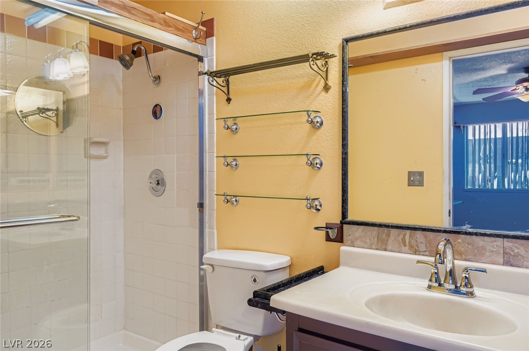4723 Desert Vista Road Las Vegas, NV 89121 - Photo 17 of 29 Bathroom featuring vanity, a shower stall, and ceiling fan