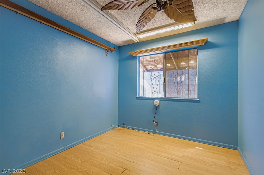 4723 Desert Vista Road Las Vegas, NV 89121 - Photo 19 of 29 Spare room with a textured ceiling, wood finished floors, and ceiling fan