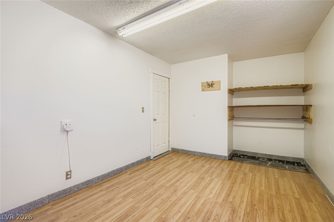 4723 Desert Vista Road Las Vegas, NV 89121 - Photo 22 of 29 Spare room featuring a textured ceiling and wood finished floors