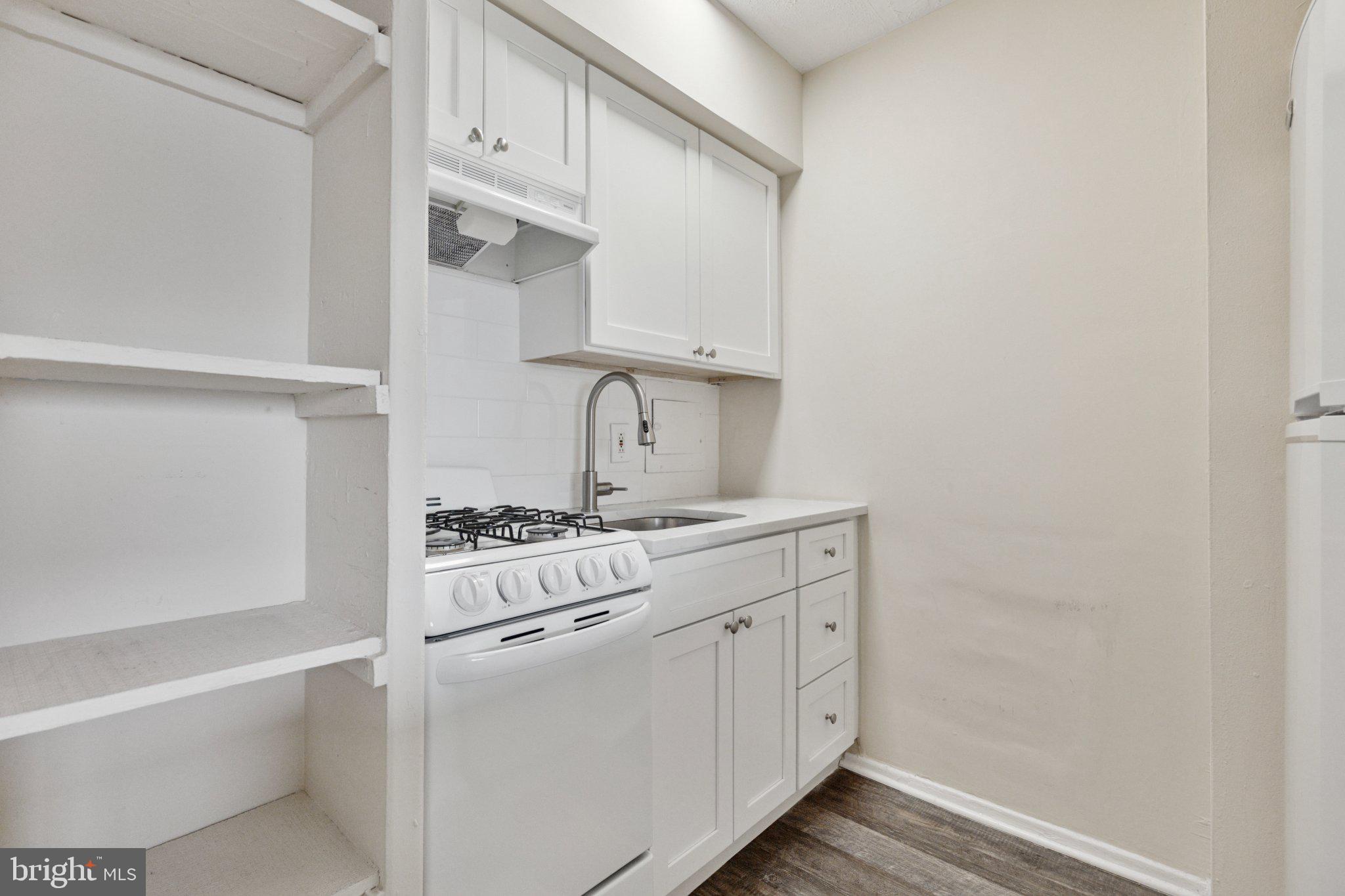 2101 Chestnut Street, Unit 1610 Philadelphia, PA 19103 - Photo 6 of 15 a kitchen with white cabinets and white appliances