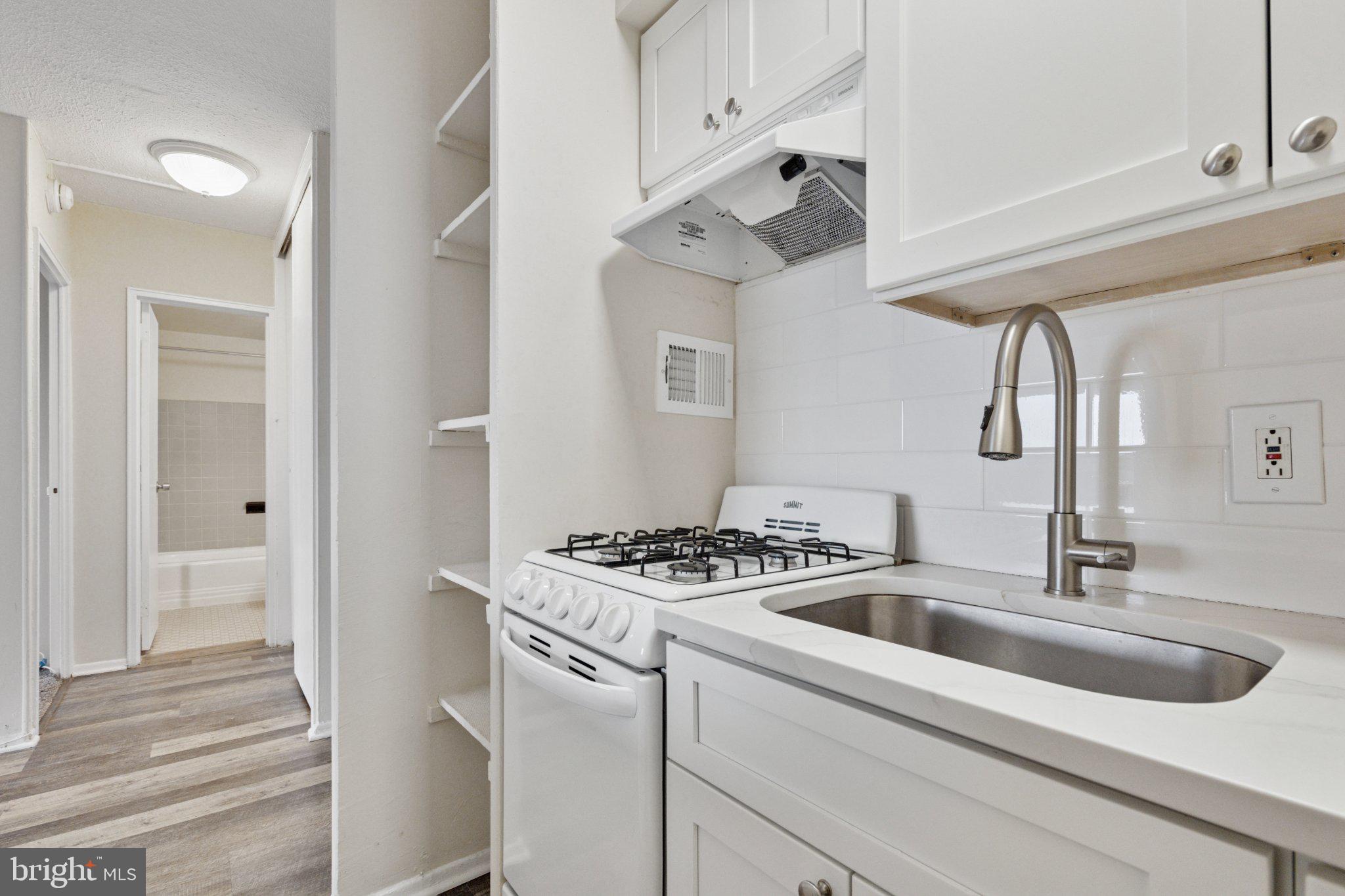 2101 Chestnut Street, Unit 1610 Philadelphia, PA 19103 - Photo 7 of 15 a kitchen with a sink a stove and refrigerator