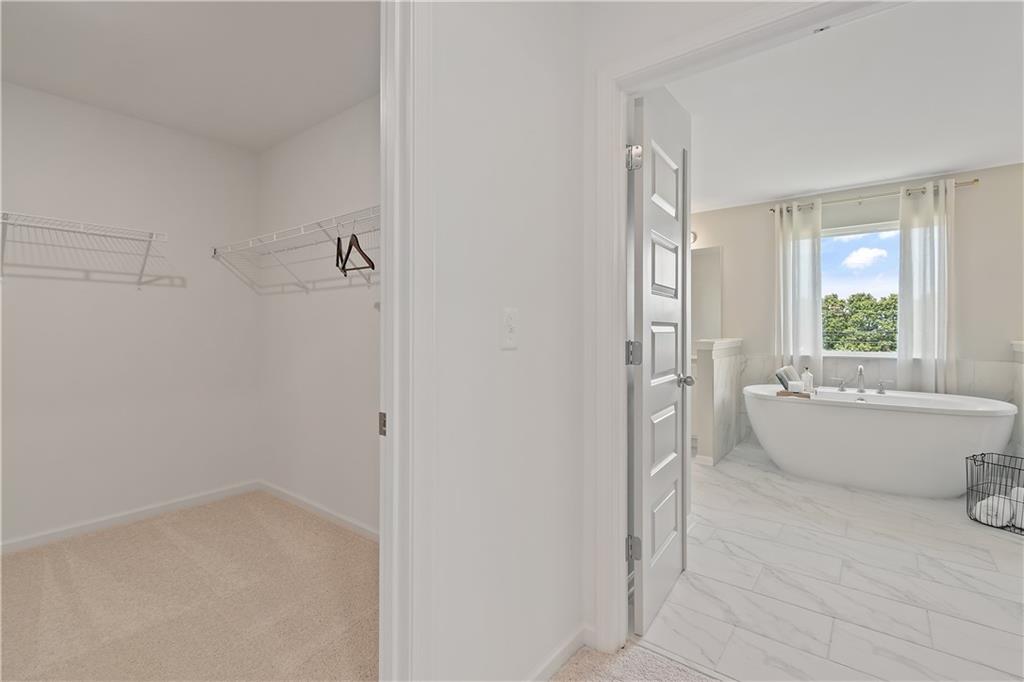 157 Haverling Pass Atlanta, GA 30349 - Photo 41 of 45 a bathroom with a tub shower and window