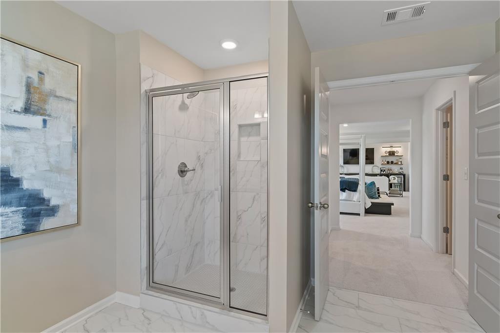 157 Haverling Pass Atlanta, GA 30349 - Photo 44 of 45 a view of a hallway with shelves and a bathroom