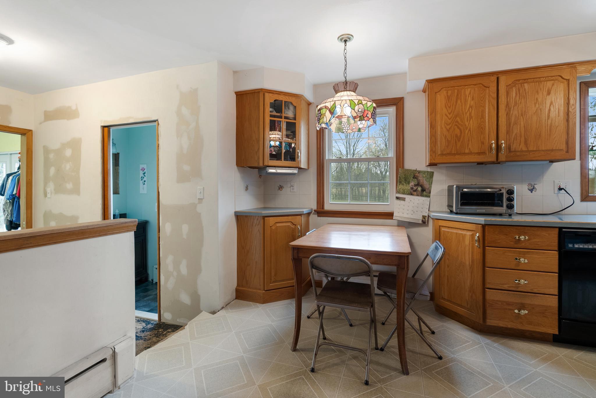 33 Derstine Road Hatfield, PA 19440 - Photo 11 of 32 a kitchen with a refrigerator a stove a sink and a dining table with wooden floor
