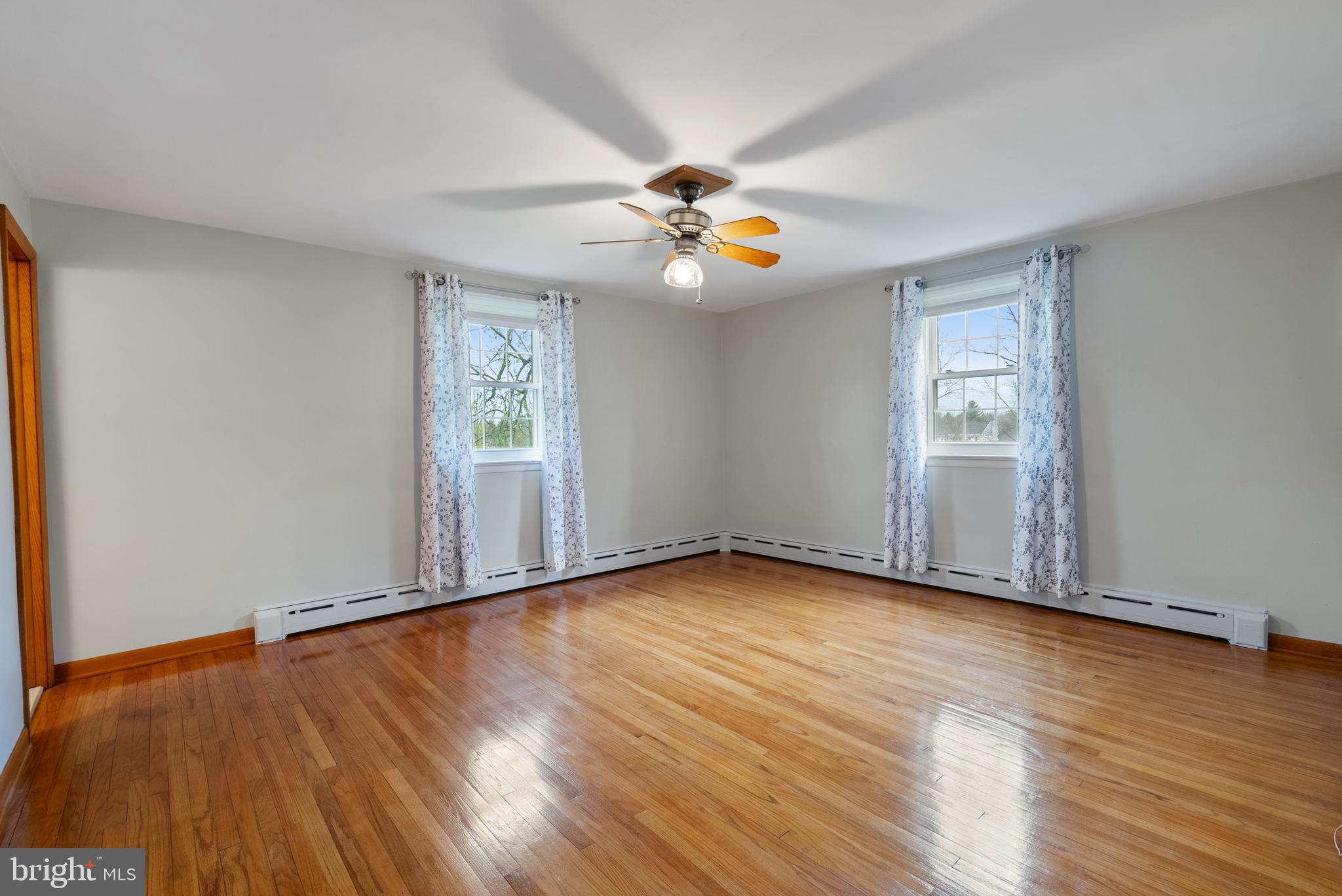 33 Derstine Road Hatfield, PA 19440 - Photo 24 of 32 an empty room with wooden floor fan and windows