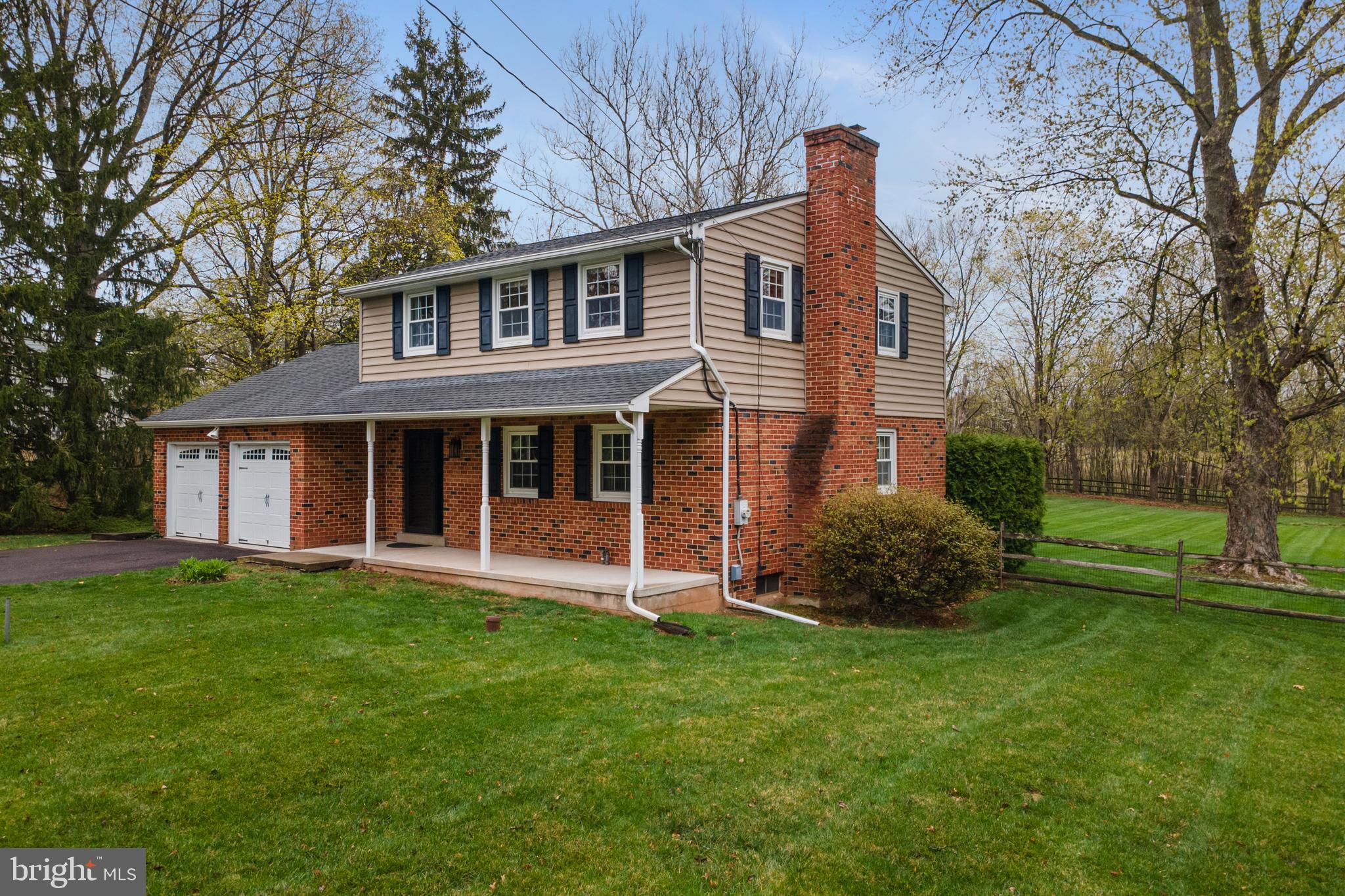 33 Derstine Road Hatfield, PA 19440 - Photo 31 of 32 a front view of a house with a garden and plants
