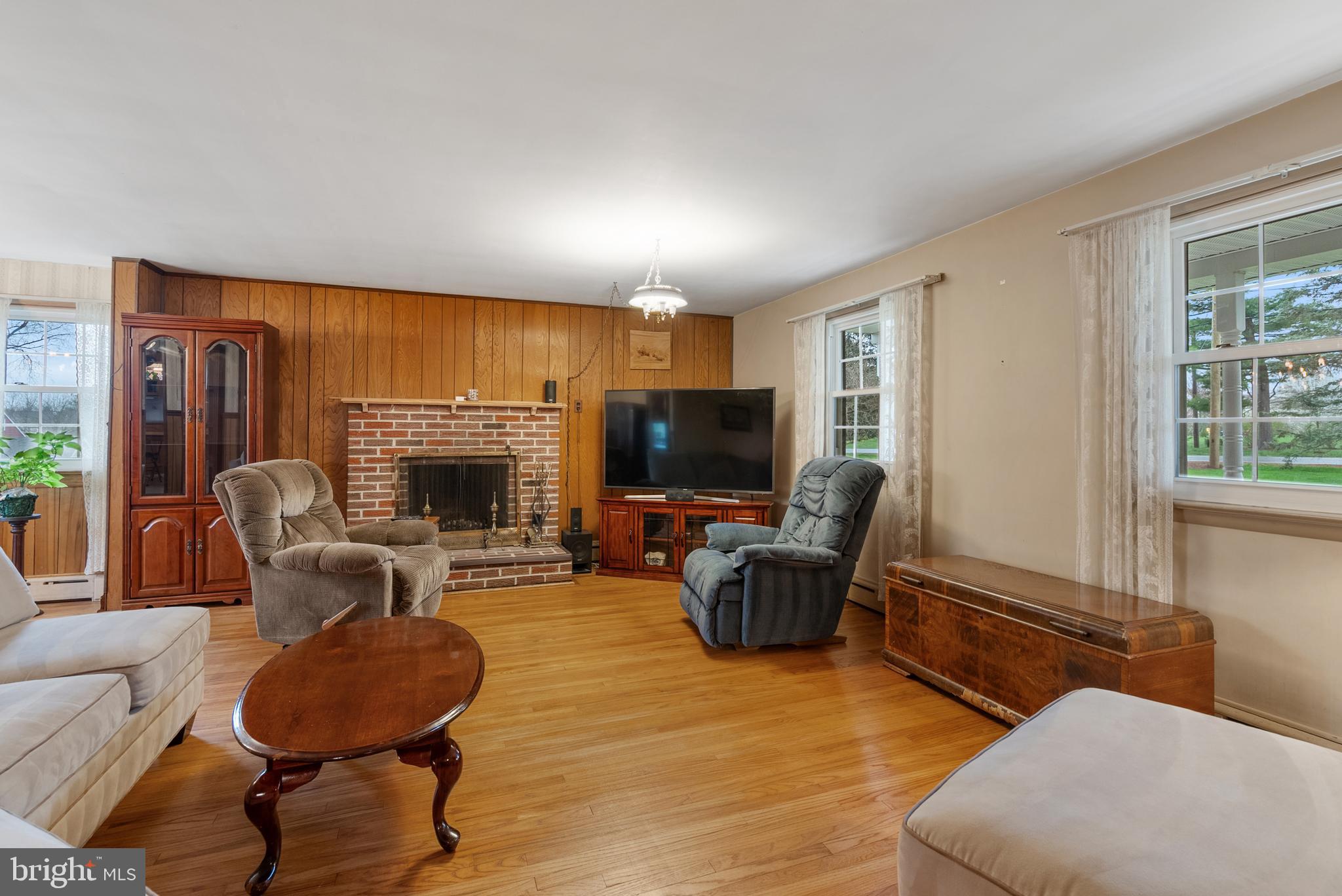 33 Derstine Road Hatfield, PA 19440 - Photo 4 of 32 a living room with furniture a flat screen tv and a fireplace