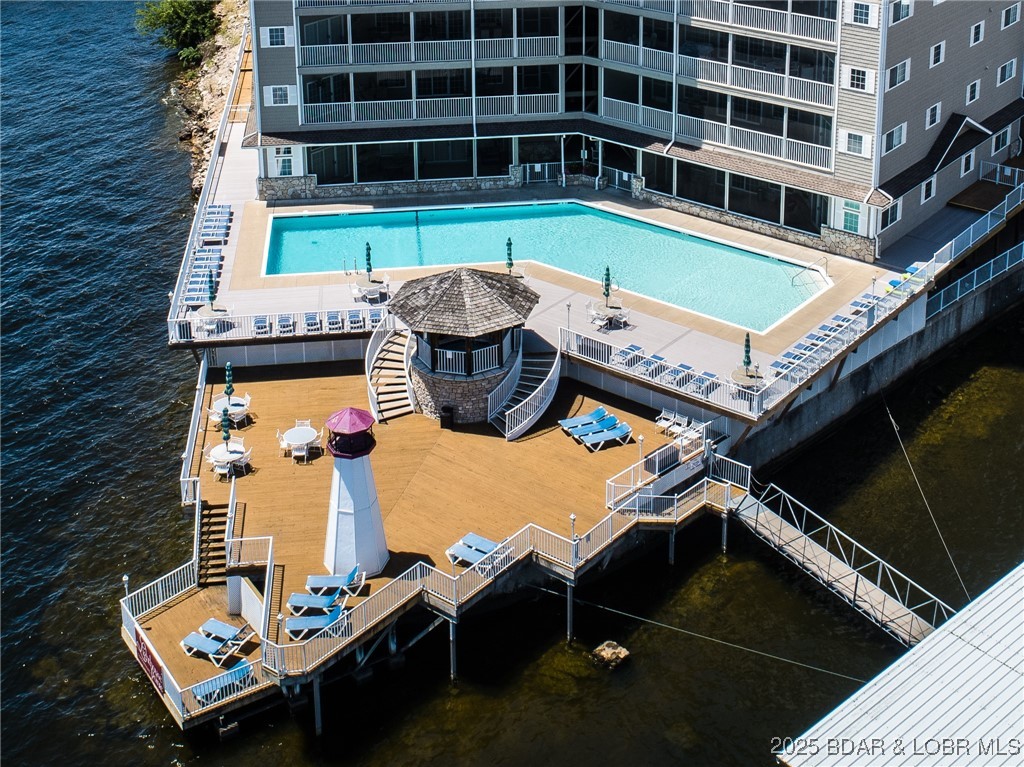 68 Lighthouse Road, Unit 133 Lake Ozark, MO 65049 - Photo 32 of 38 Resort style pool with hot tub and plenty of deck