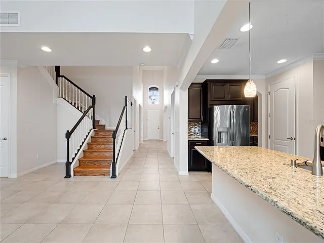 a bathroom with a granite countertop sink a toilet and a large mirror