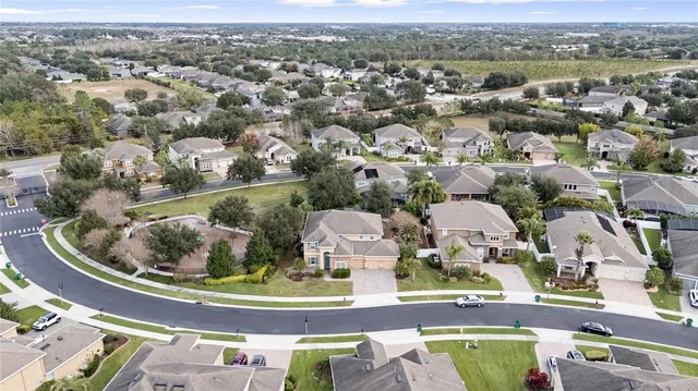 an aerial view of a house with a yard