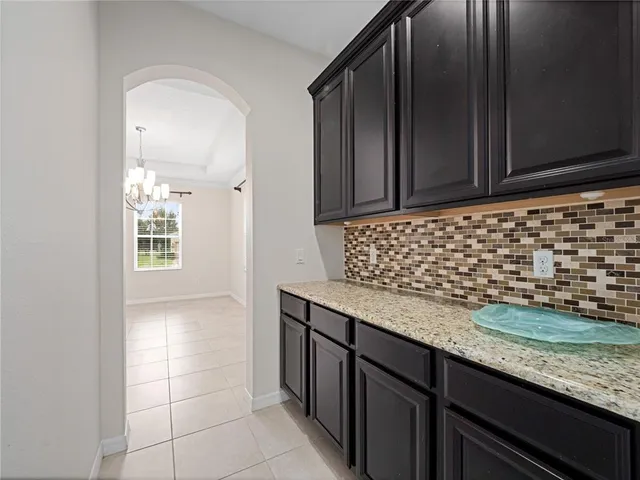a kitchen with granite countertop cabinets and window