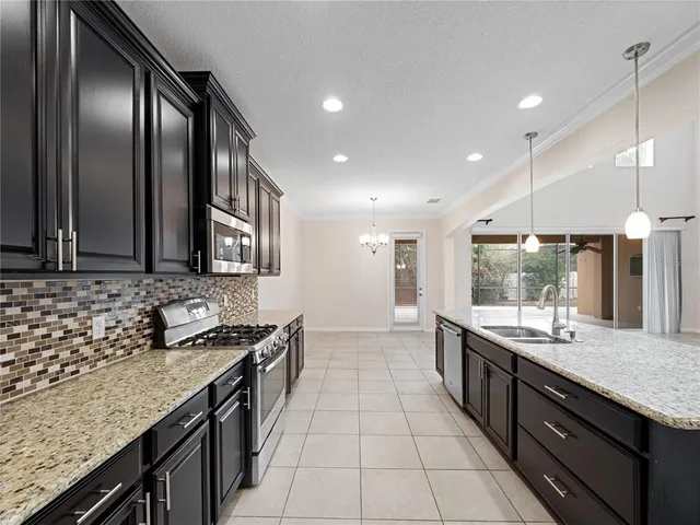 a bathroom with a granite countertop sink and a large mirror