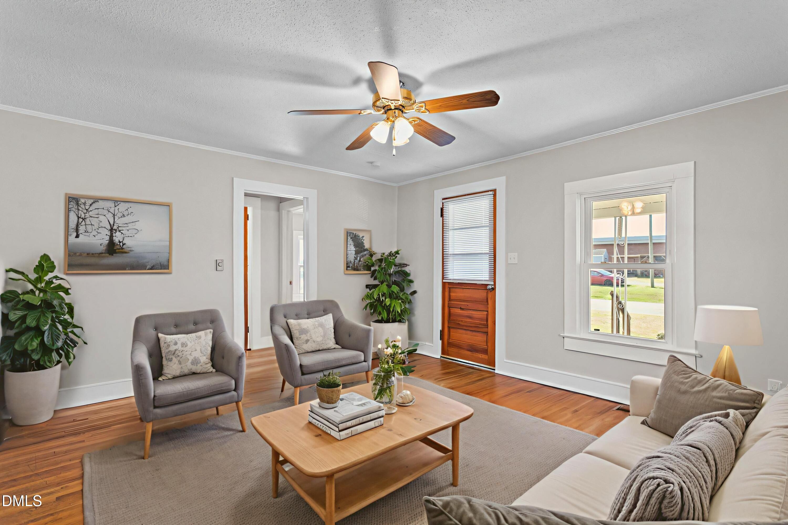2221 Gerringer Mill Road Elon, NC 27244 - Photo 10 of 39 a living room with furniture a potted plant and a window