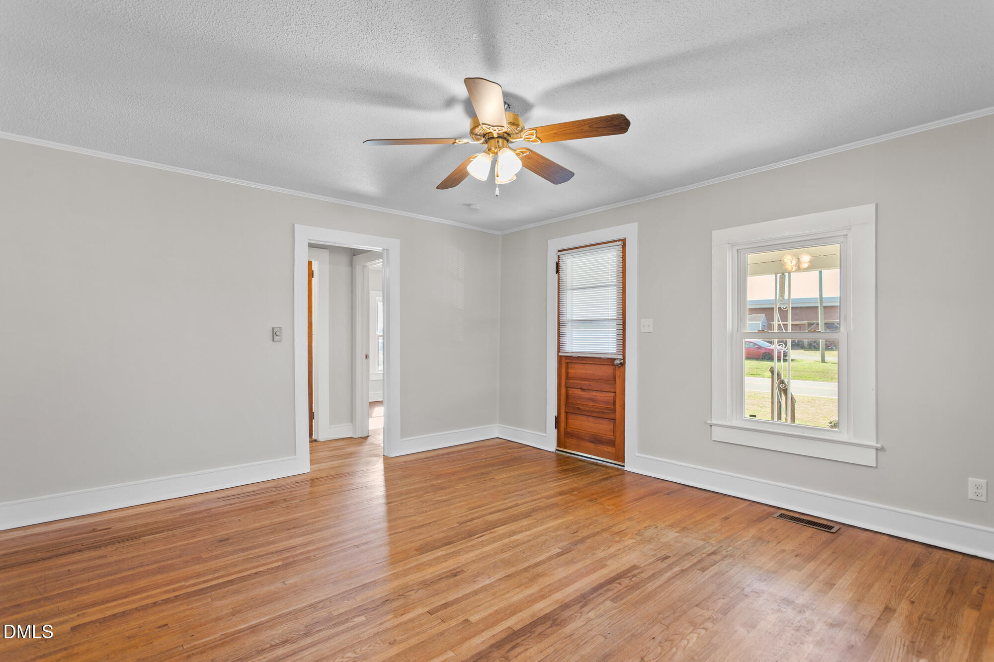 2221 Gerringer Mill Road Elon, NC 27244 - Photo 11 of 39 an empty room with wooden floor closet and windows