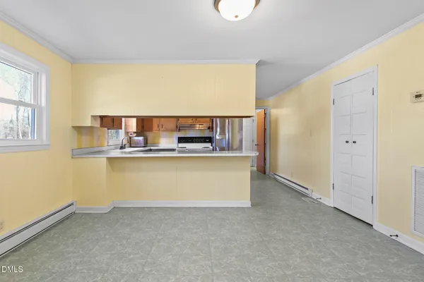a kitchen with stainless steel appliances a refrigerator and a stove top oven