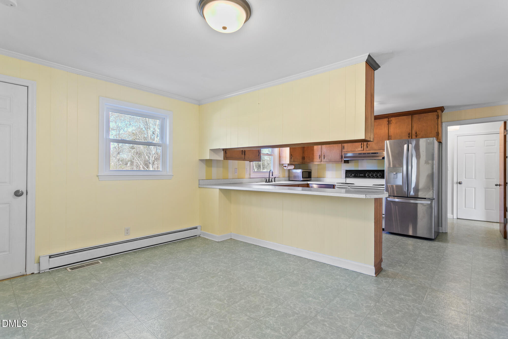 2221 Gerringer Mill Road Elon, NC 27244 - Photo 13 of 39 a kitchen with stainless steel appliances a refrigerator and a stove top oven