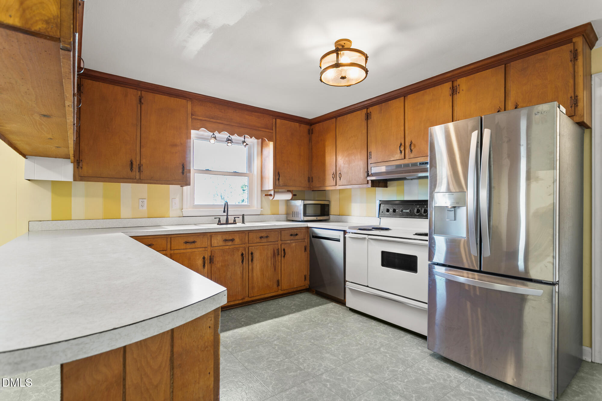 2221 Gerringer Mill Road Elon, NC 27244 - Photo 16 of 39 a kitchen with stainless steel appliances a refrigerator sink and stove