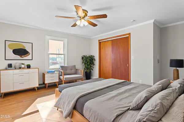 a bedroom with a bed and a window