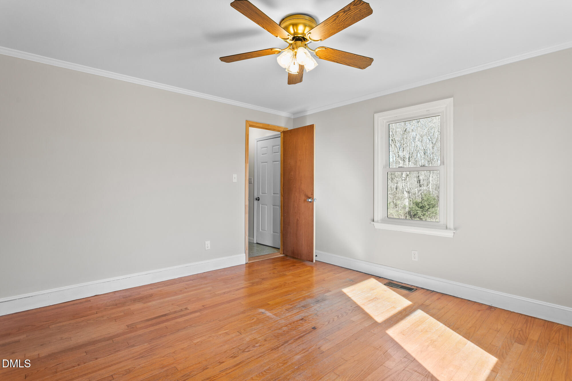 2221 Gerringer Mill Road Elon, NC 27244 - Photo 24 of 39 wooden floor in an empty room with a window