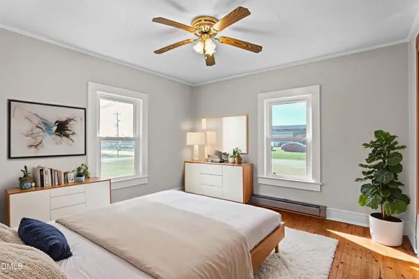 a bedroom with a bed and wooden floor