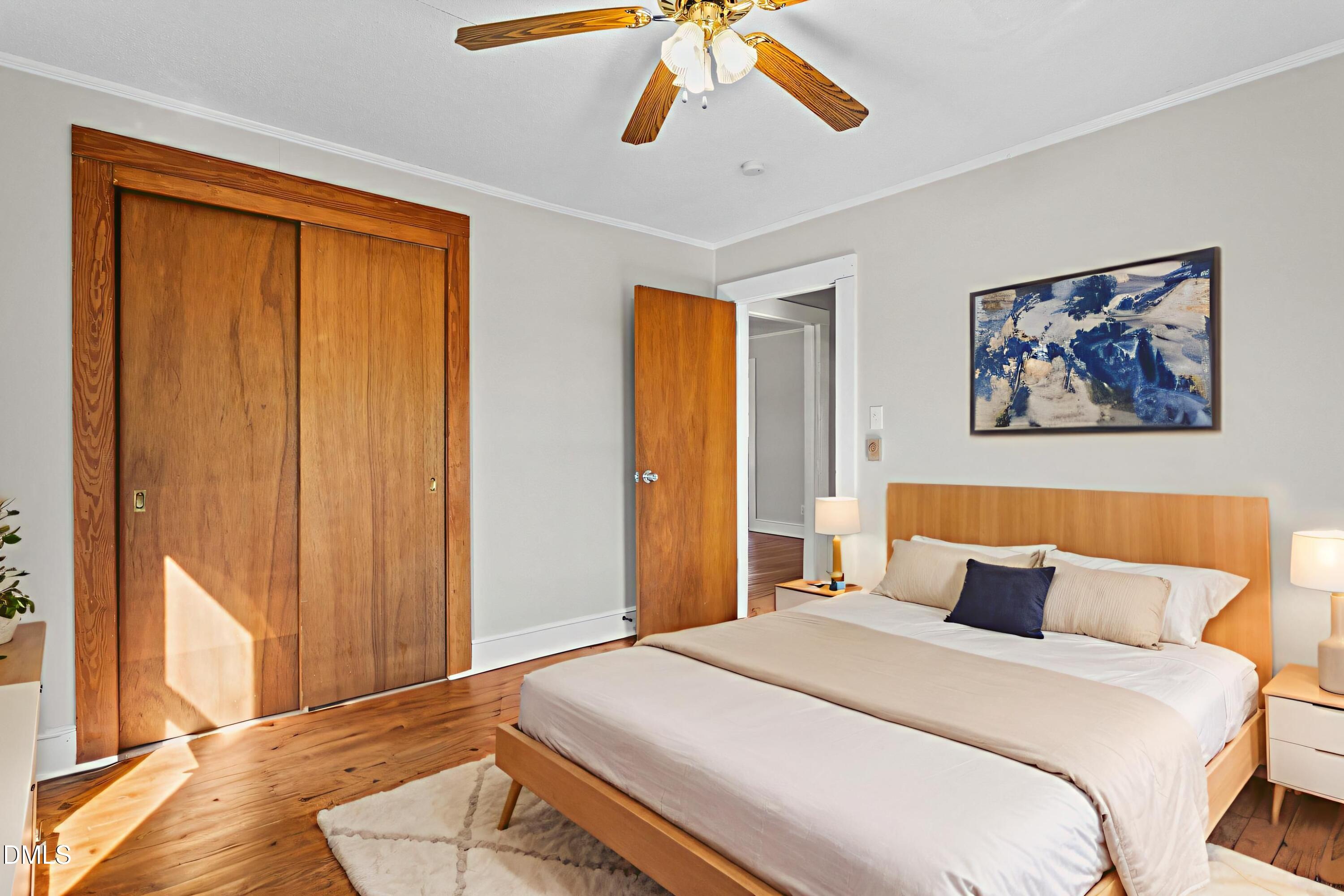 2221 Gerringer Mill Road Elon, NC 27244 - Photo 27 of 39 a bedroom with a bed and wooden floor