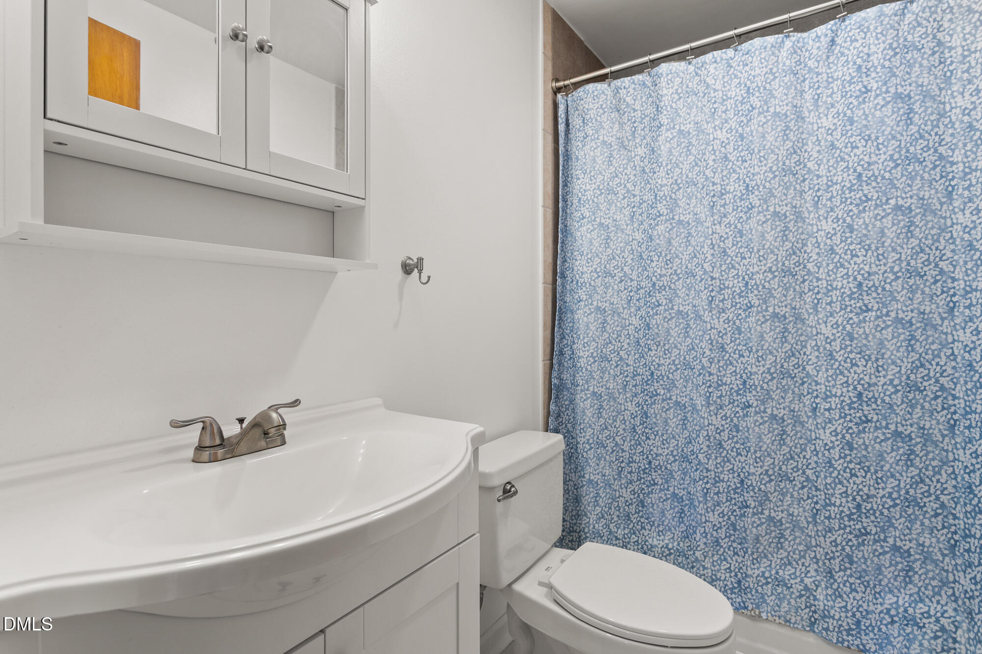 2221 Gerringer Mill Road Elon, NC 27244 - Photo 29 of 39 a white toilet sitting next to a bathroom sink