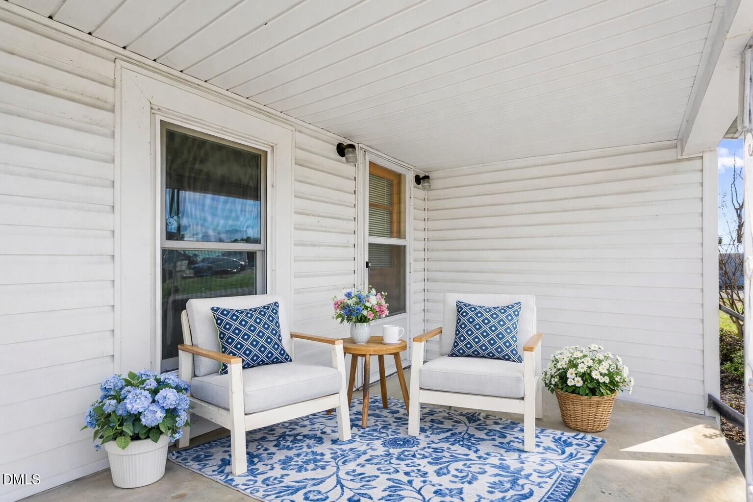 2221 Gerringer Mill Road Elon, NC 27244 - Photo 5 of 39 a outdoor living space with furniture and a potted plant