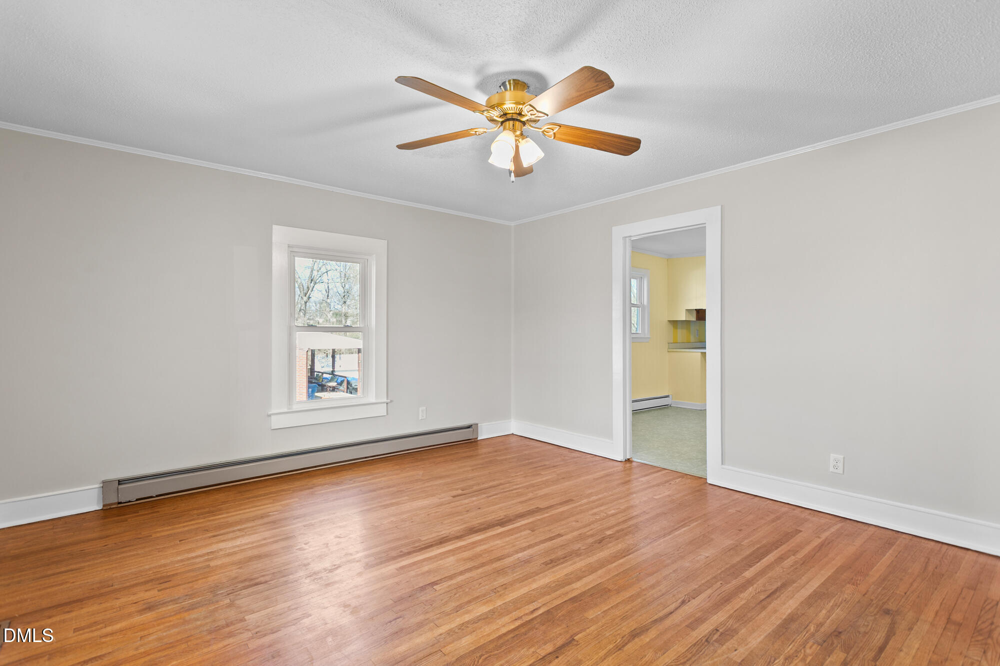 2221 Gerringer Mill Road Elon, NC 27244 - Photo 9 of 39 a view of an empty room with wooden floor and a window