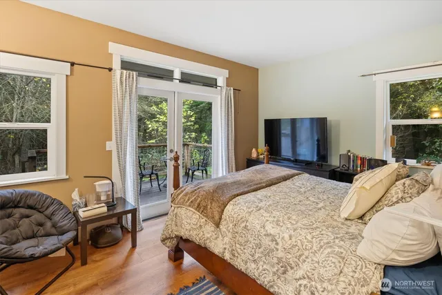 a bedroom with a bed and a large window