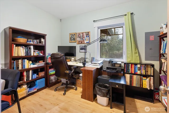 a view of a workspace with furniture and a bookshelf