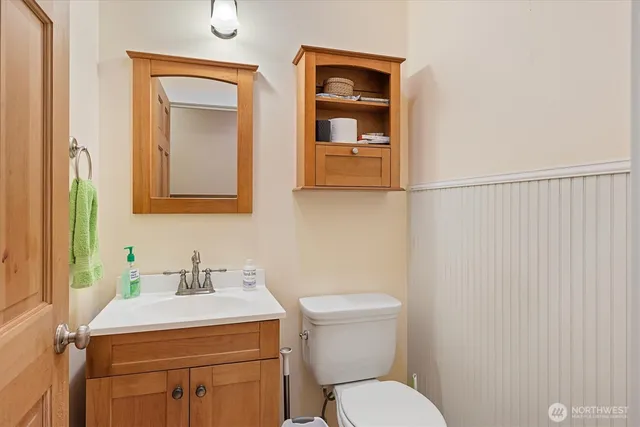 a bathroom with a toilet sink and mirror