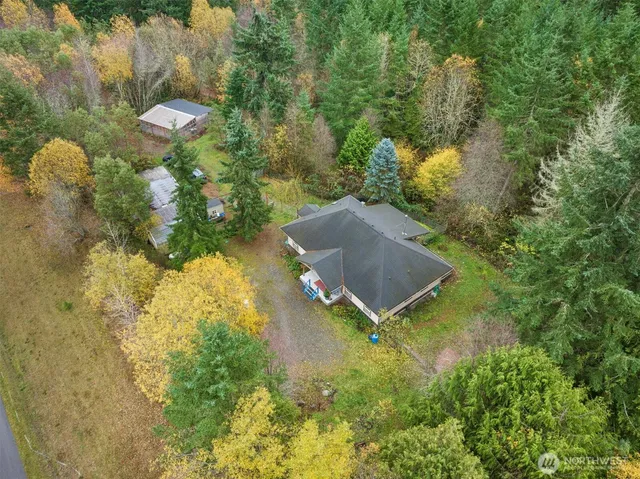 a aerial view of a house with yard and outdoor seating