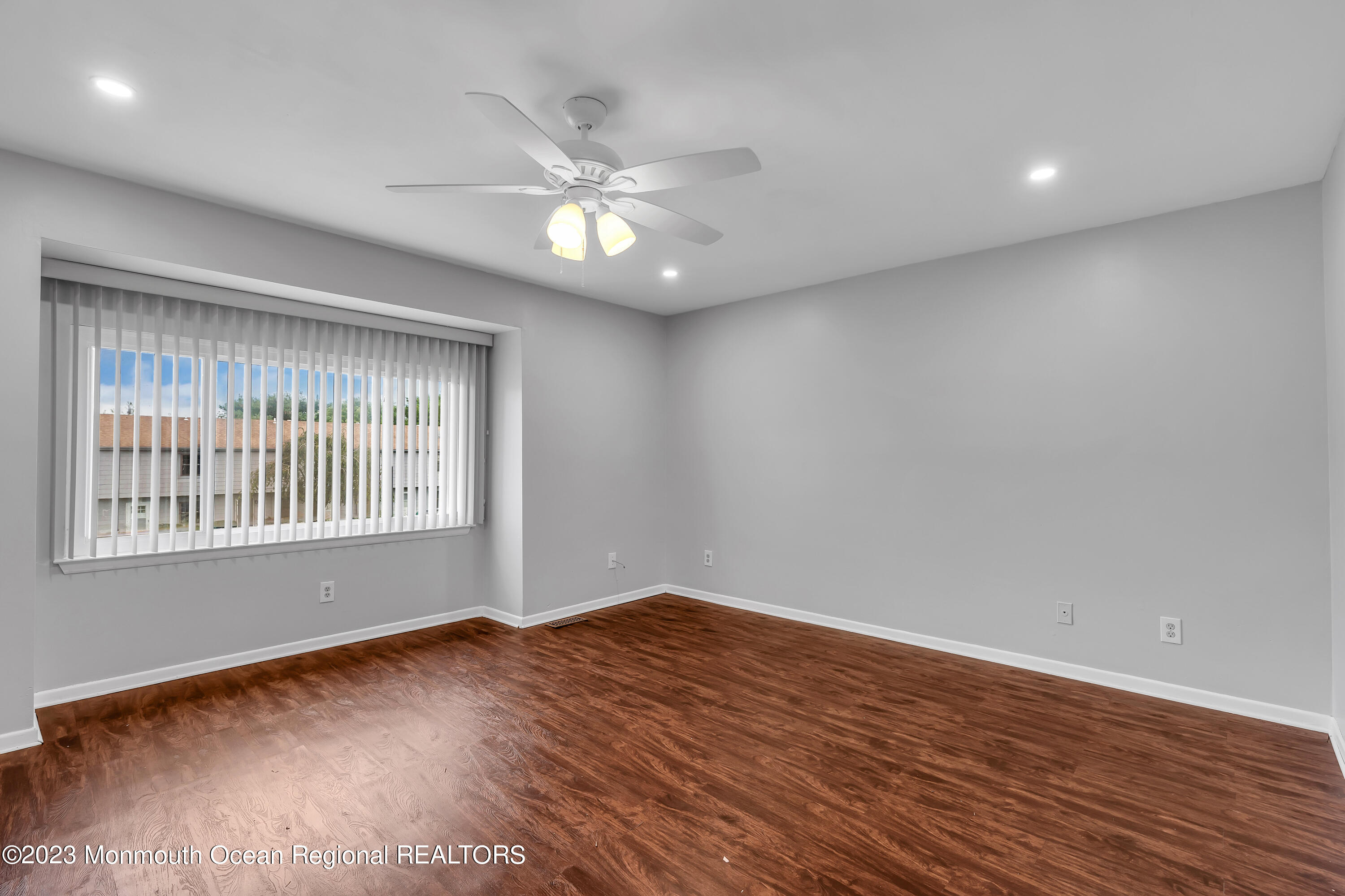 1110 Sawmill Road, Unit 103 Brick, NJ 08724 - Photo 11 of 13 a view of an empty room with wooden floor and a window
