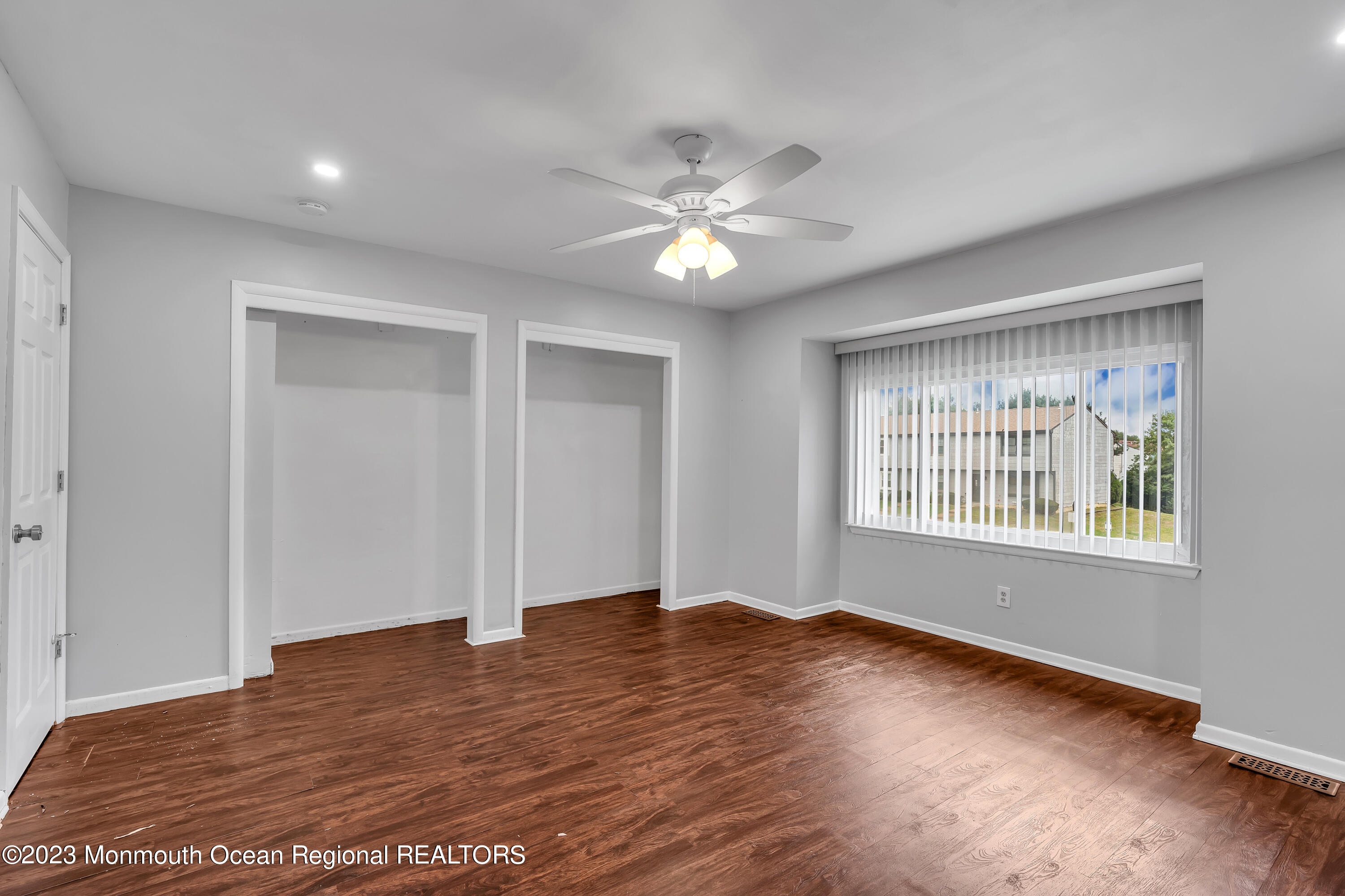 1110 Sawmill Road, Unit 103 Brick, NJ 08724 - Photo 8 of 13 a view of an empty room with wooden floor and a window
