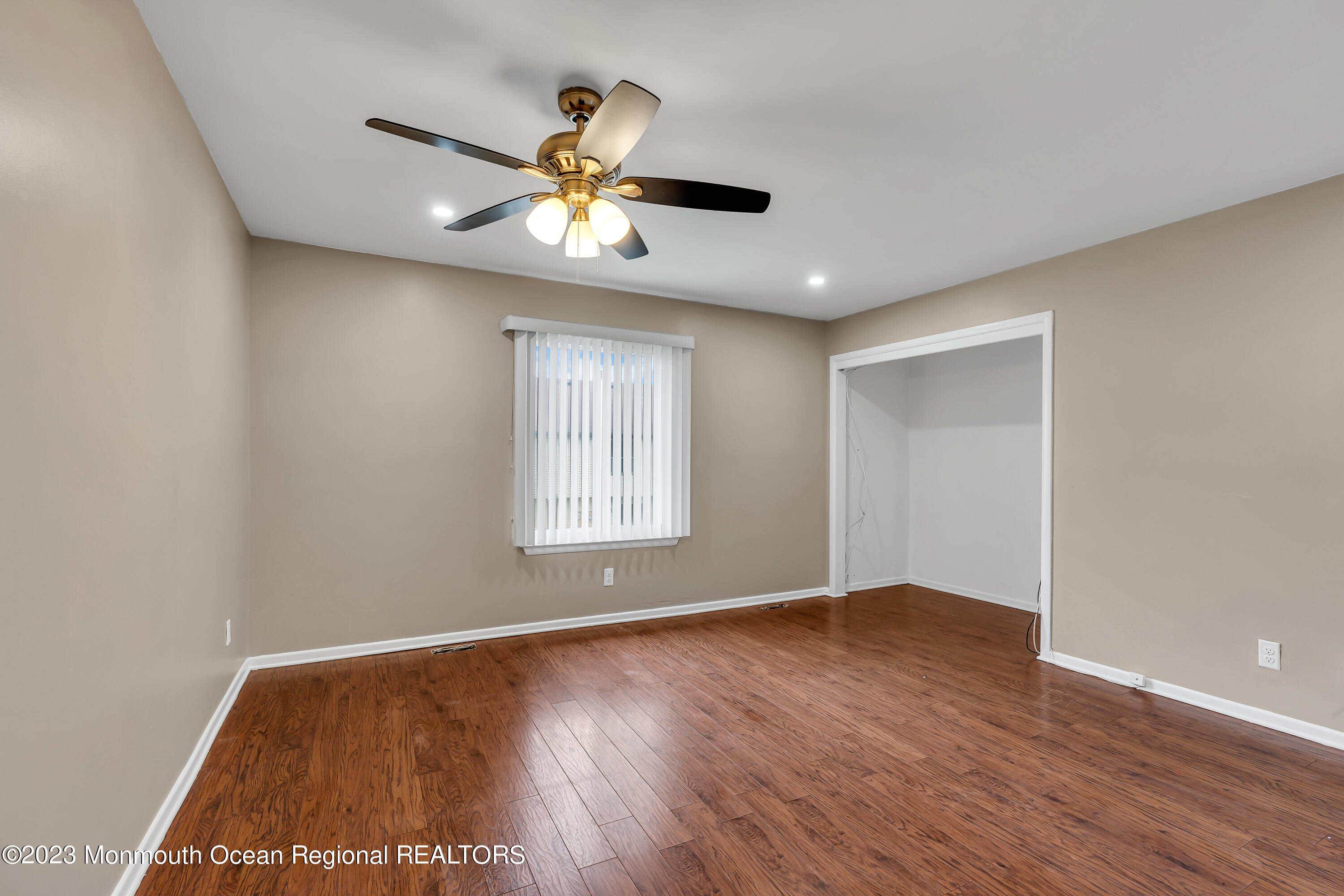 1110 Sawmill Road, Unit 103 Brick, NJ 08724 - Photo 10 of 13 a view of an empty room with wooden floor and a window